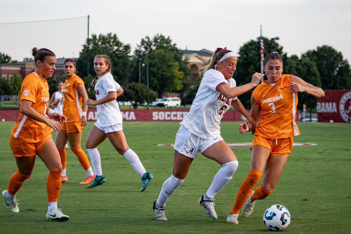 Alabama forward/midfielder Kiley Kukan (#6) battles a Tennessee player for the ball.