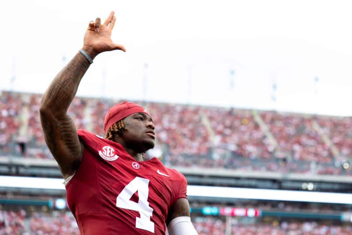 Alabama quarterback Jalen Milroe (#4) signals to the crowd prior to the game.