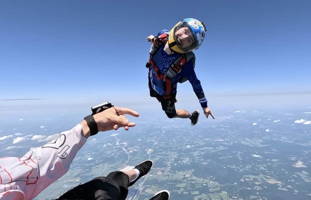 Members of the Skydiving Enthusiasts Club flying through the air.