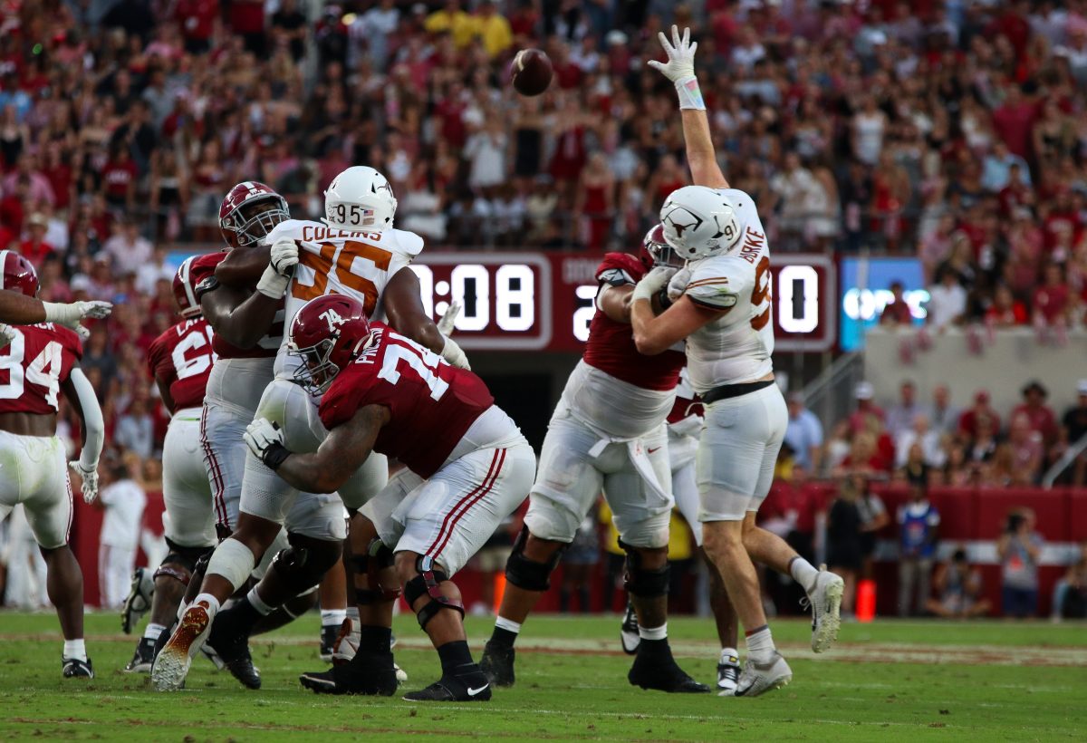 Alabama offensive lineman Kadyn Proctor (#74) blocks a Texas defender.