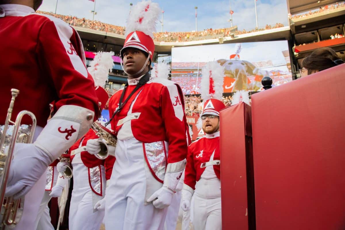 A member of the Million Dollar Band walks onto the field.