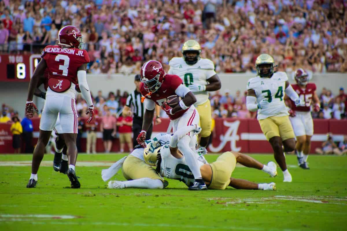 Alabama wide receiver Germie Bernard (#5) attempts to escape from South Florida defenders.