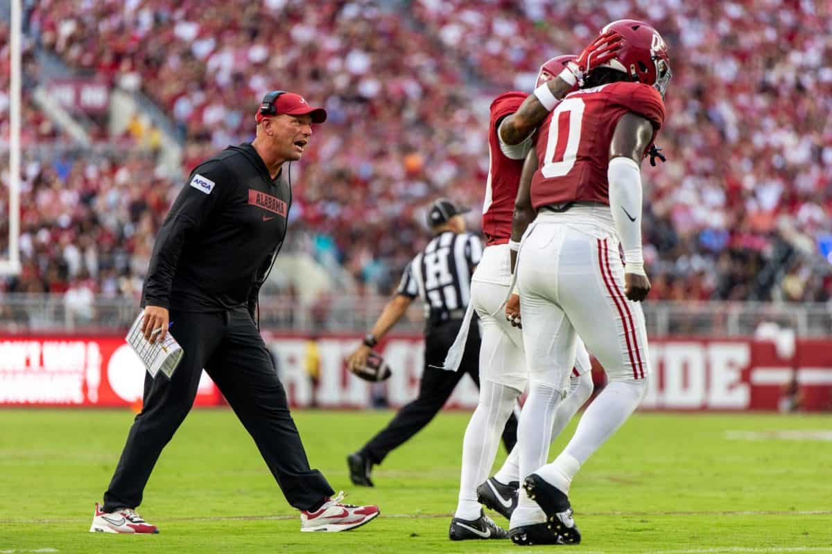 Alabama football head coach Kalen DeBoer walks from the sideline to talk to his players.