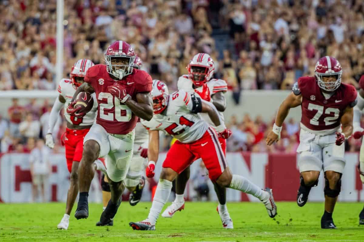 Alabama running back Jam Miller (#26) breaks away from Western Kentucky defenders.