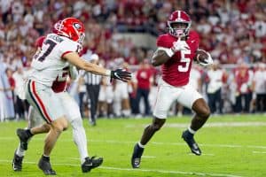 Alabama wide receiver Germie Bernard (#5) runs away from a Georgia defender.