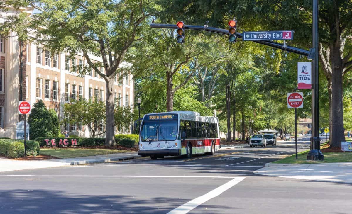 A Crimson Ride bus waits at a stop light next to the Quad.