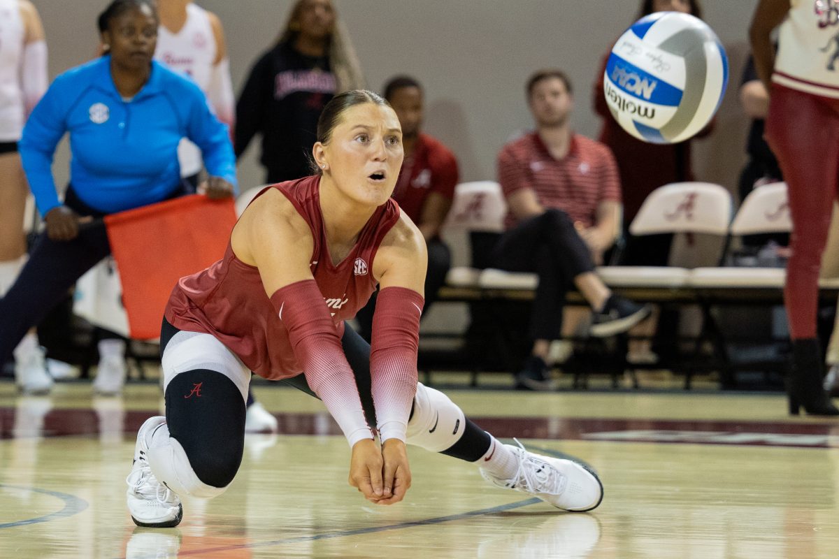 Alabama volleyball player Francesca Bertucci (#21) dives to bump the ball against Georgia.