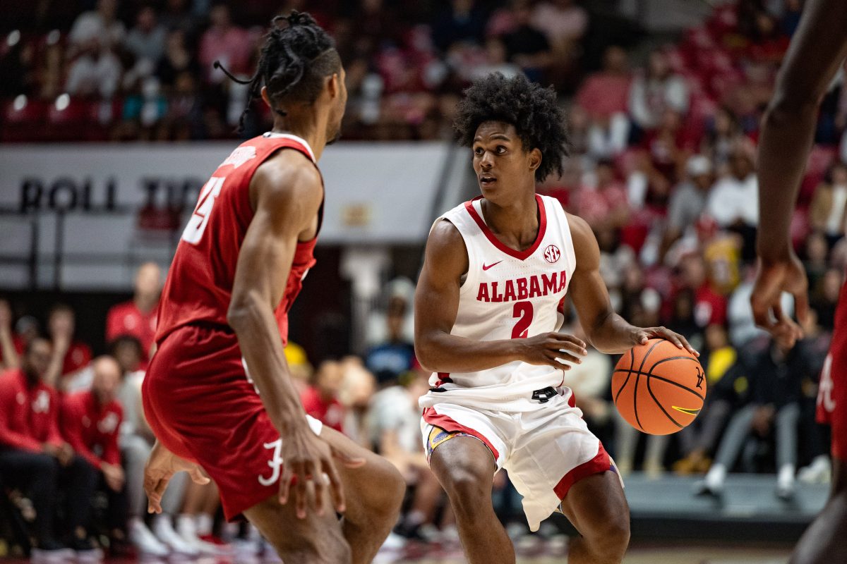 Alabama guard Aden Holloway (#2) looks down the court.