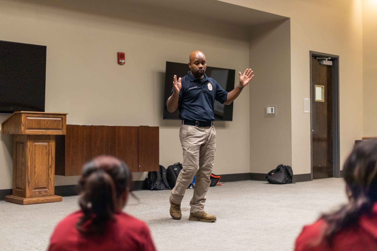 UAPD officer Marshall Wade speaks to students about self defense skills.