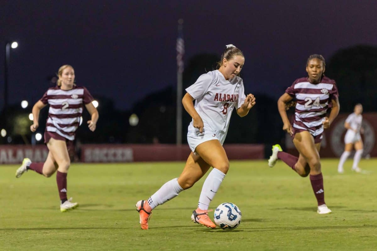 Lexi Meyer (#8) dribbles the ball away from Texas A&M defenders.