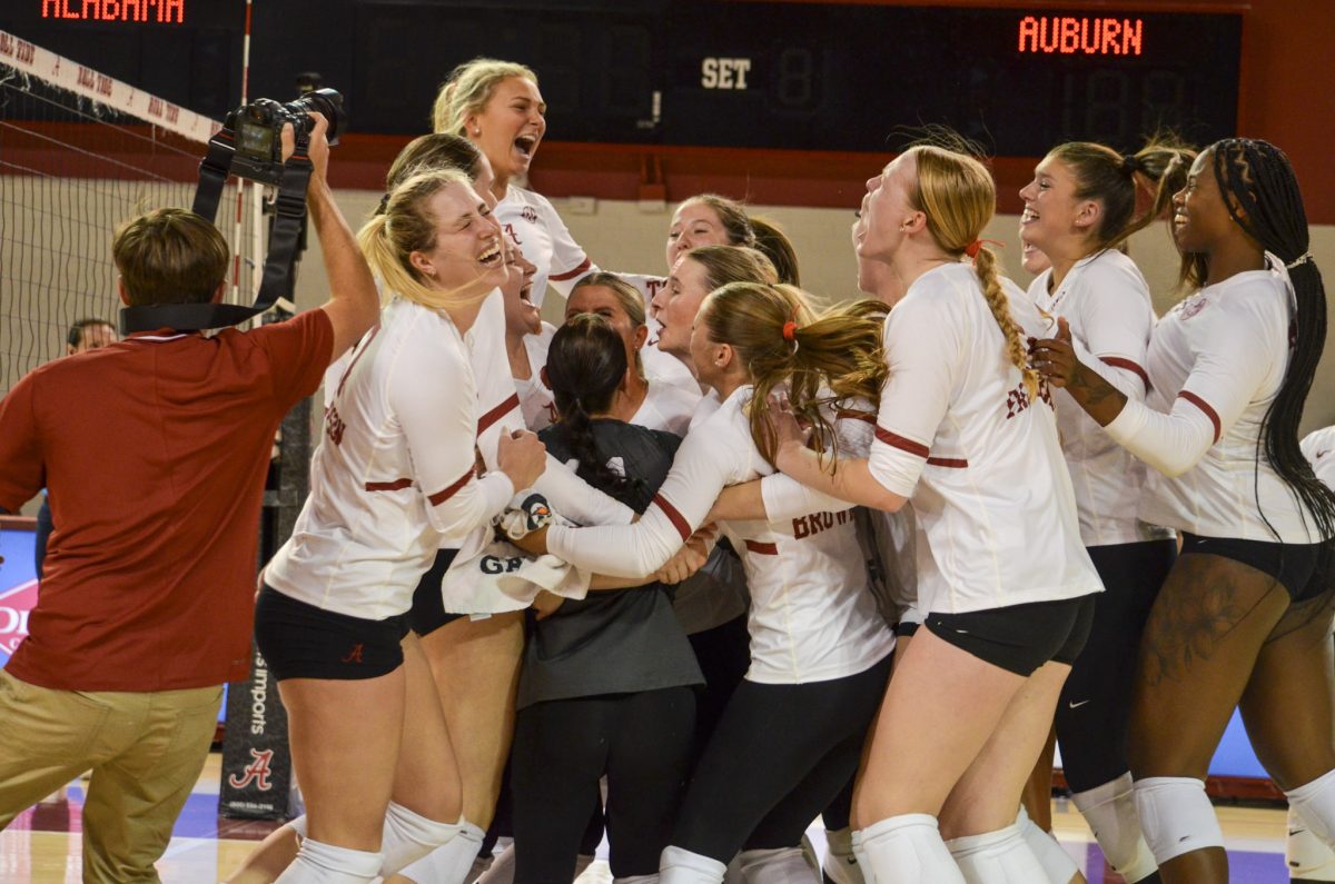 Alabama volleyball players celebrate after defeating Auburn.