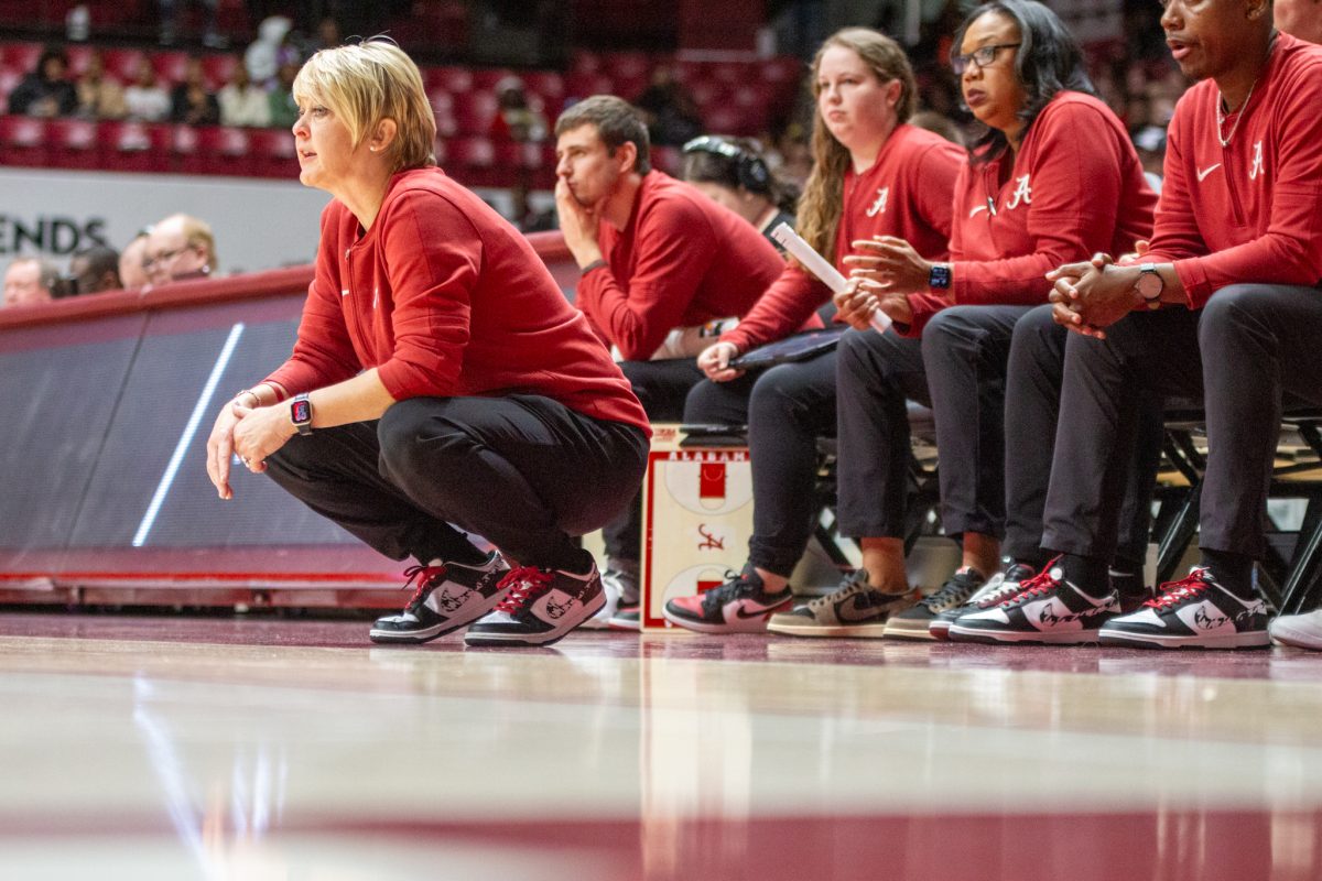 Alabama women's basketball coach Kristy Curry sits on the sideline. 