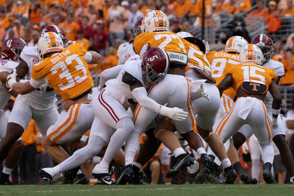 Alabama defensive back King Mack (#5)  tackles a Tennessee player.