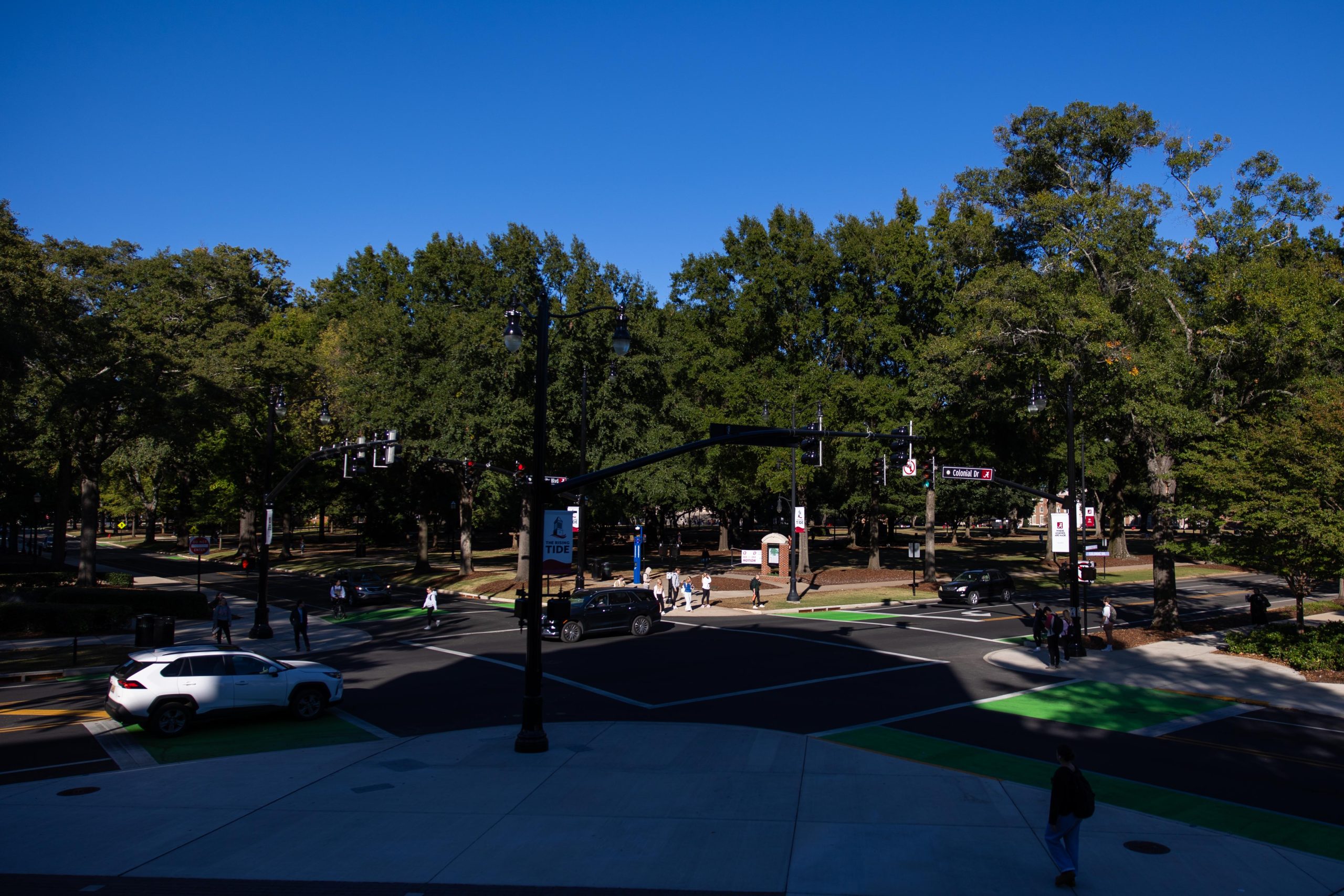 Cars drive through an intersection in front of Reese Phifer Hall.