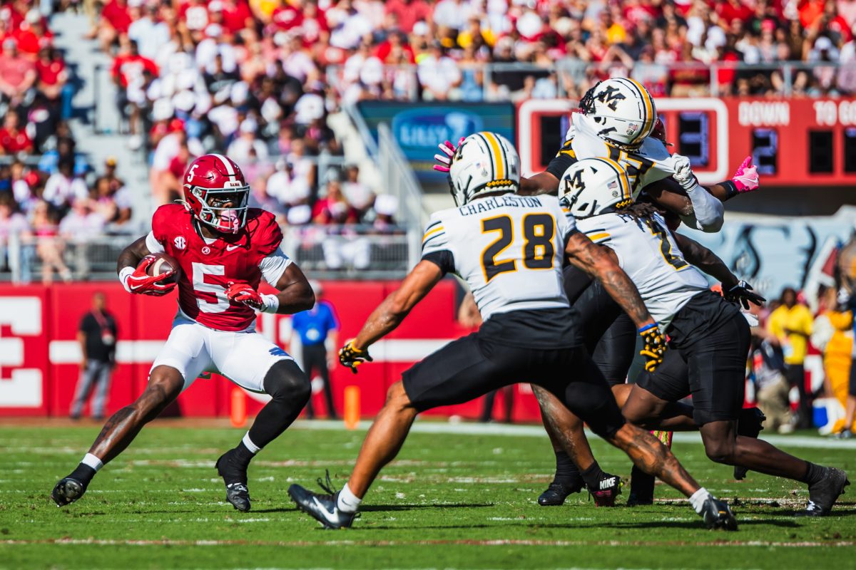 Alabama wide receiver Germie Bernard (#5) attempts to juke out a group of Missouri defenders at Saban Field at Bryant-Denny Stadium in Tuscaloosa, AL on Oct. 26, 2024.