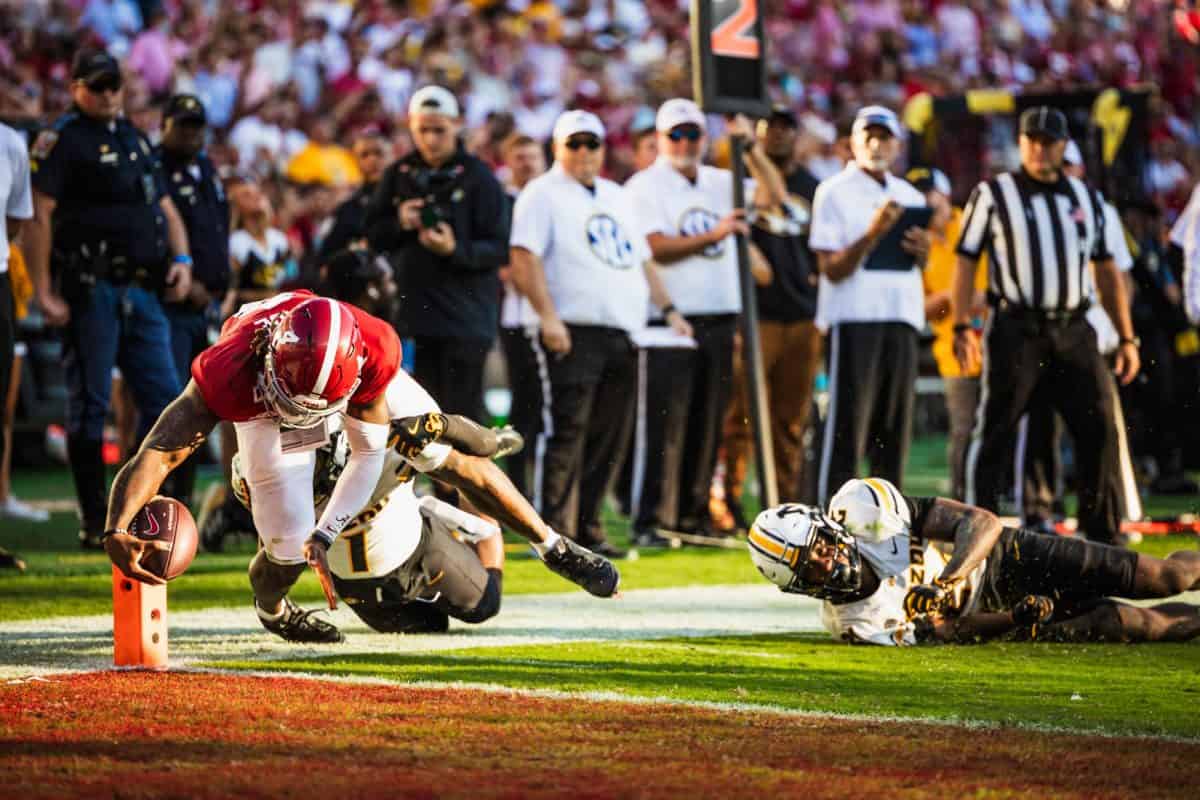 Alabama quarterback Jalen Milroe (#4) dives into the end zone against Missouri.