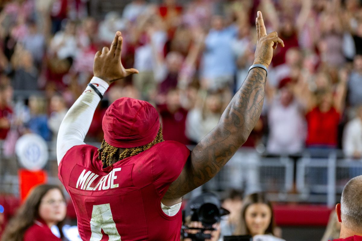 Alabama quarterback Jalen Milroe (#4) signals to the crowd. 