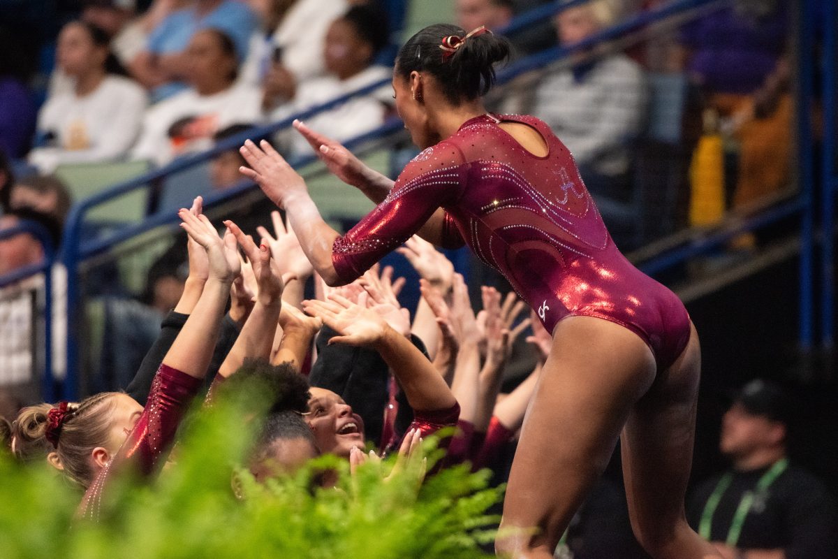 Alabama gymnasts cheer each other on during the 2024 SEC Gymnastics Championship.