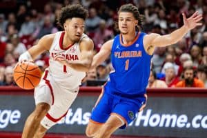 Alabama guard Mark Sears (#1) dribbles around a Florida defender.