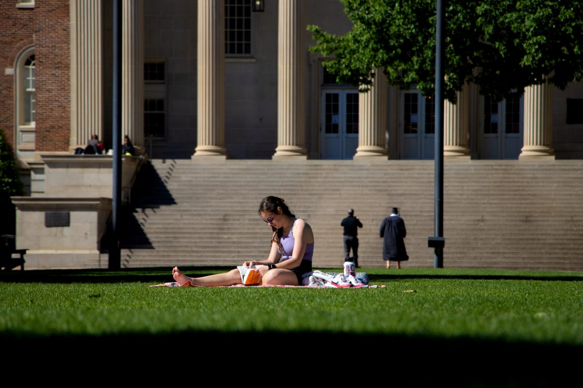 A student sits alone on the Quad.