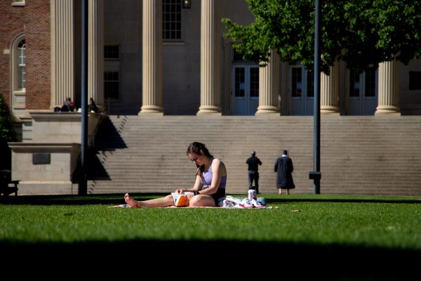 A student sits alone on the Quad.