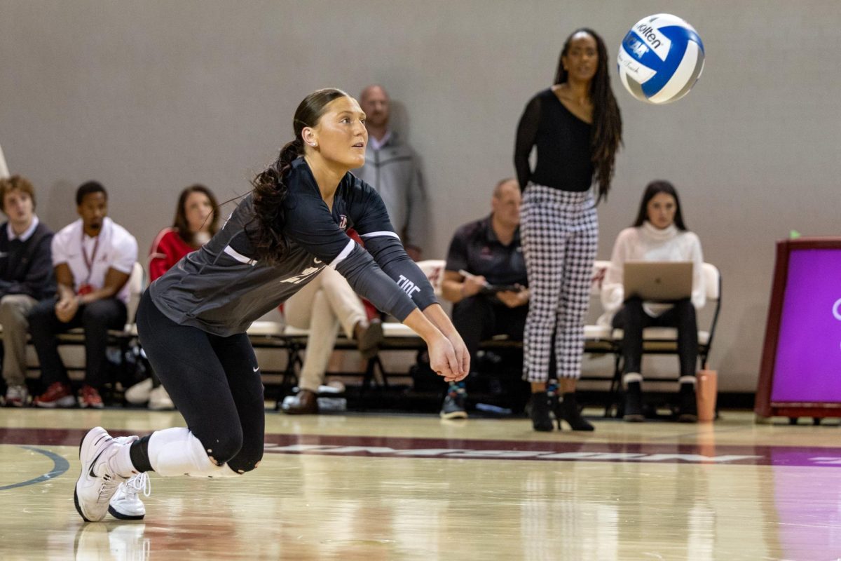 Libero Francesca Bertucci (#21) digs the ball in Alabama's game against South Carolina. 