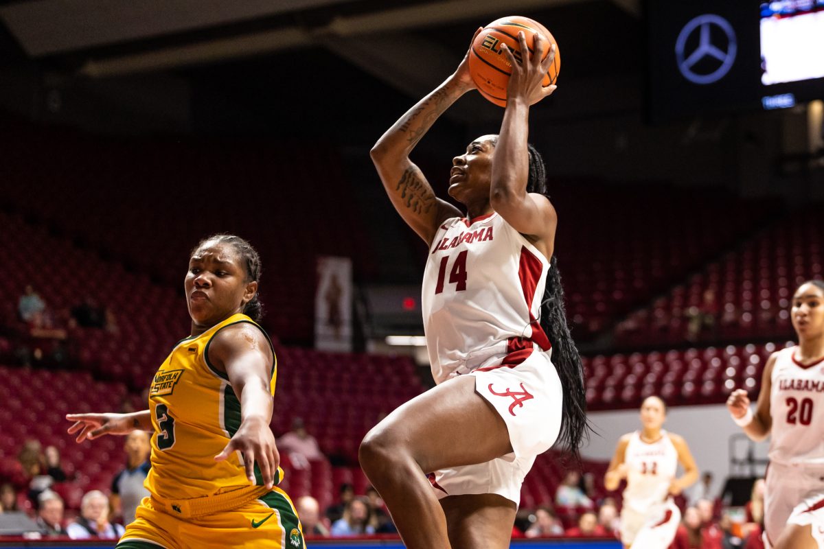 Guard Zaay Green (#14) shoots against defender in Alabama's game against Norfolk State. 