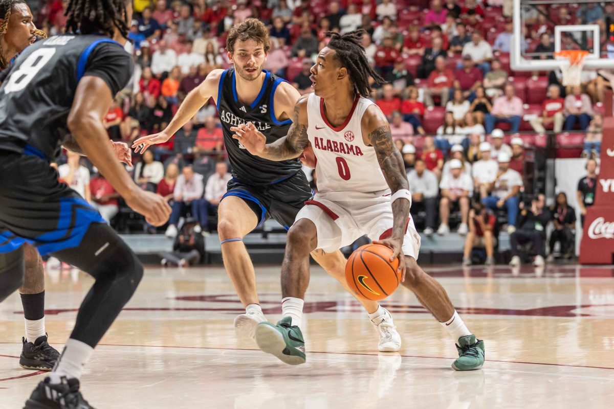 Guard Labaron Philon (#0) dribbles past a defender in Alabama's game against the University of North Carolina Asheville on Monday, Nov. 4. 