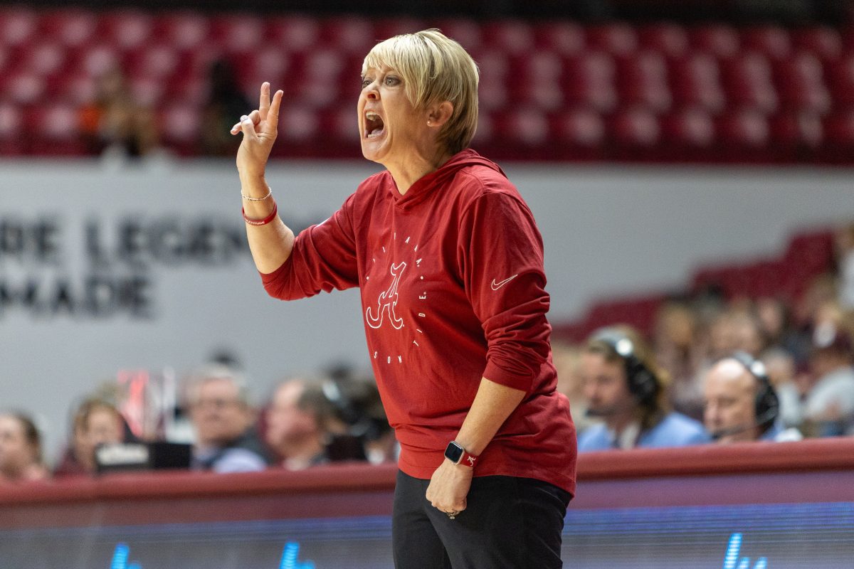 Alabama head coach Kristy Curry watches from the sideline.