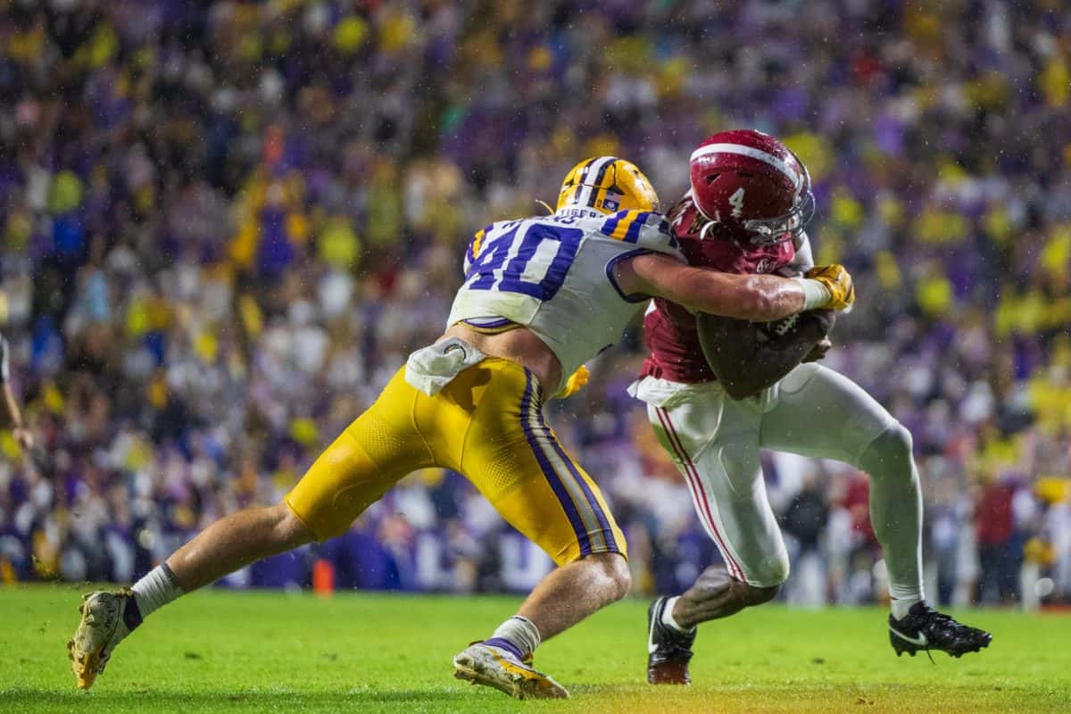 Alabama quarterback Jalen Milroe (#4) attempts to break a tackle against LSU.