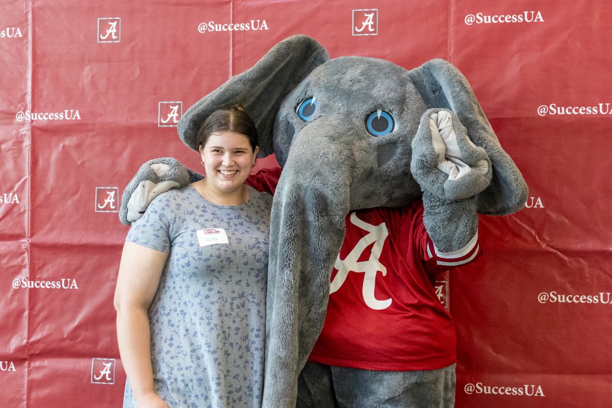 Student poses with Big Al during an event for the week of celebration in honor of National First-Generation College Student Day. 