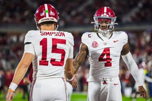 Alabama quarterbacks Jalen Milroe (#4) and Ty Simpson (#15) meet before the game against Oklahoma.