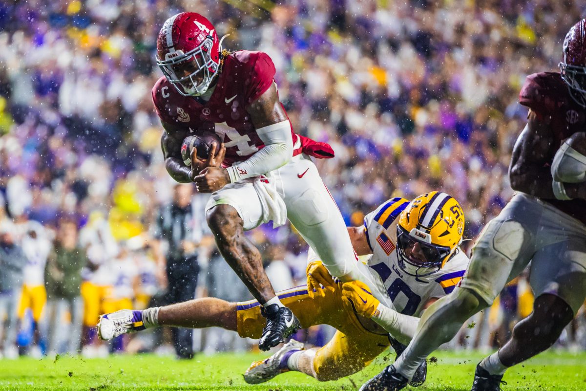 Alabama quarterback Jalen Milroe (#4) breaks through a tackle to score a touchdown against LSU.