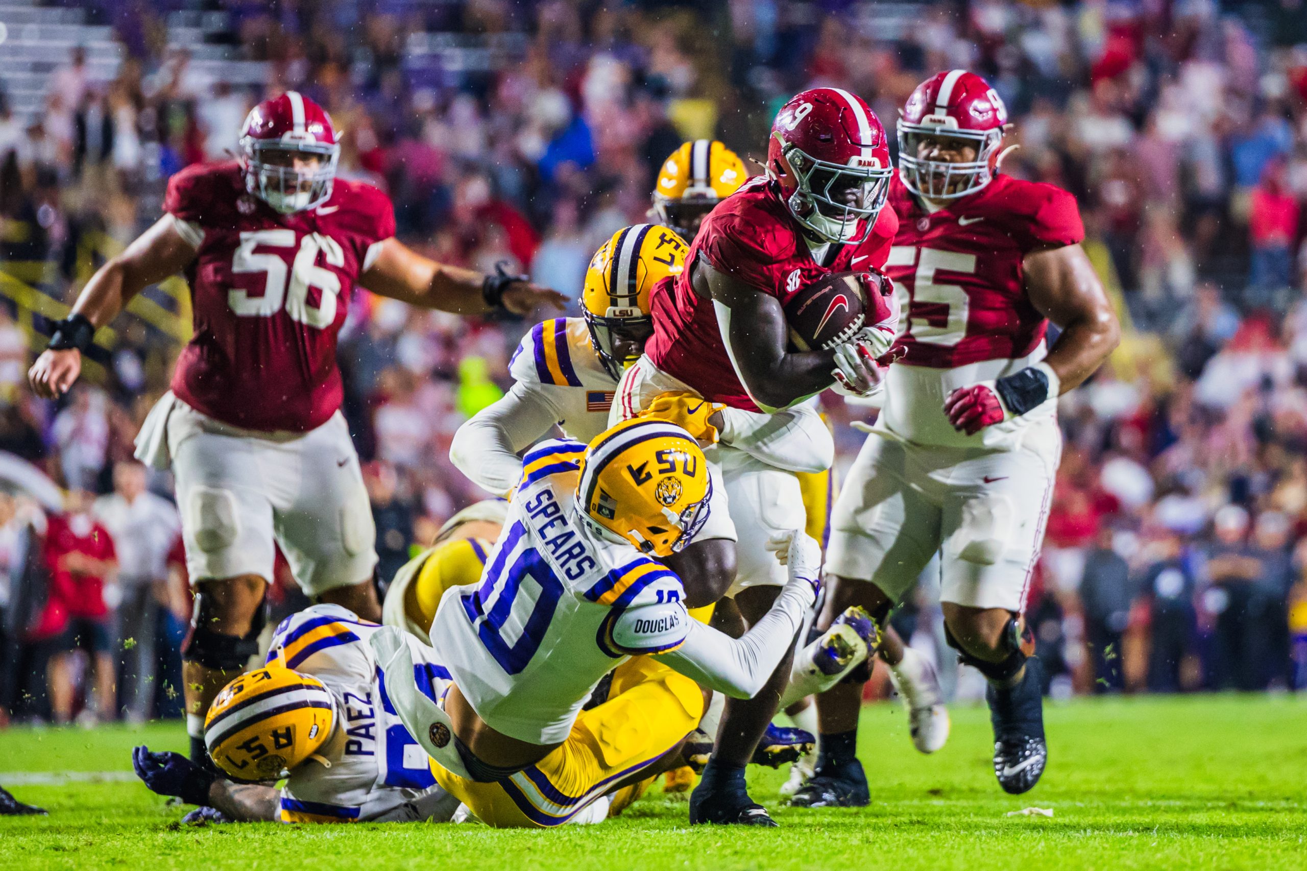 Alabama running back Richard Young (#9) attempts to break a tackle against LSU.