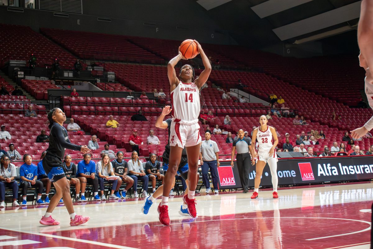 Alabama guard Zaay Green (#14) jumps up to take a shot against New Orleans.