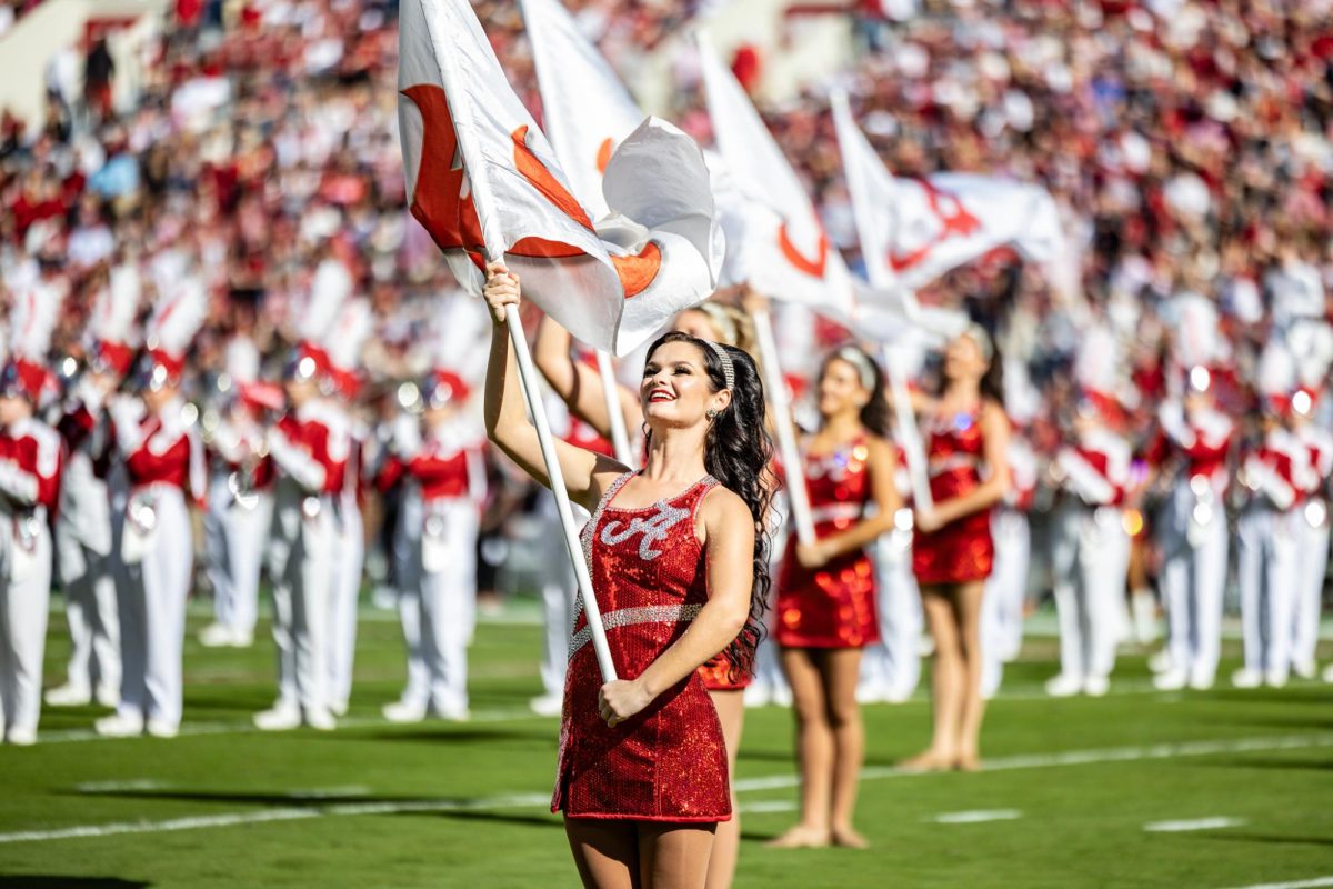 An Alabama Colorguard member performs on Saban Field at Bryant-Denny Stadium.