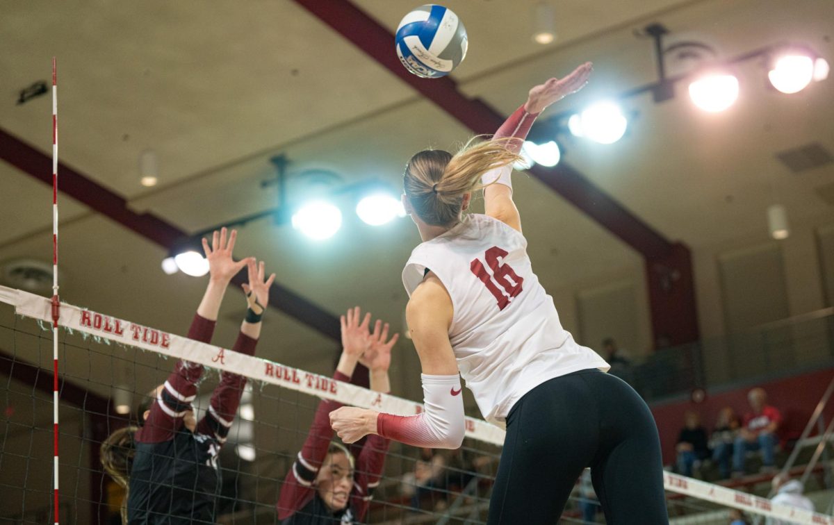 Outside hitter Sophie Agee (#16) hits the ball in Alabama's game against South Carolina. 