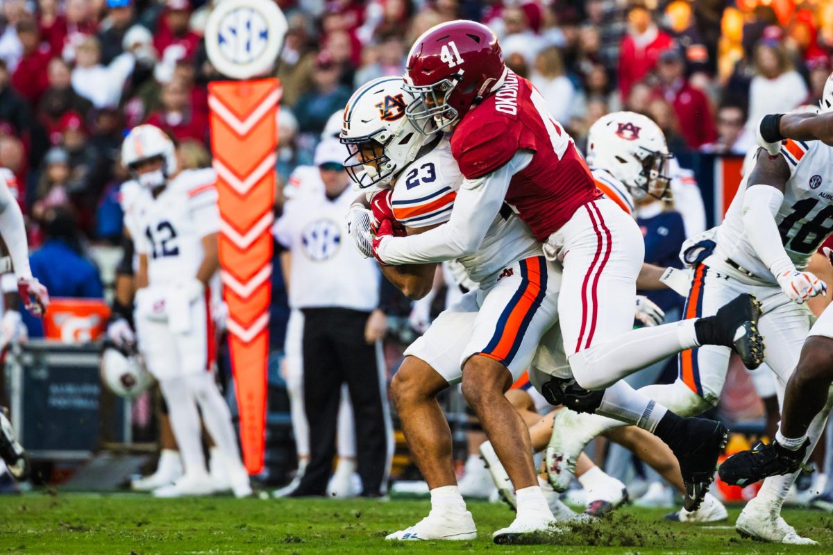 Linebacker Justin Okoronkwo (#41) tackles the ball carrier in Alabama's game against Auburn on Nov. 30.