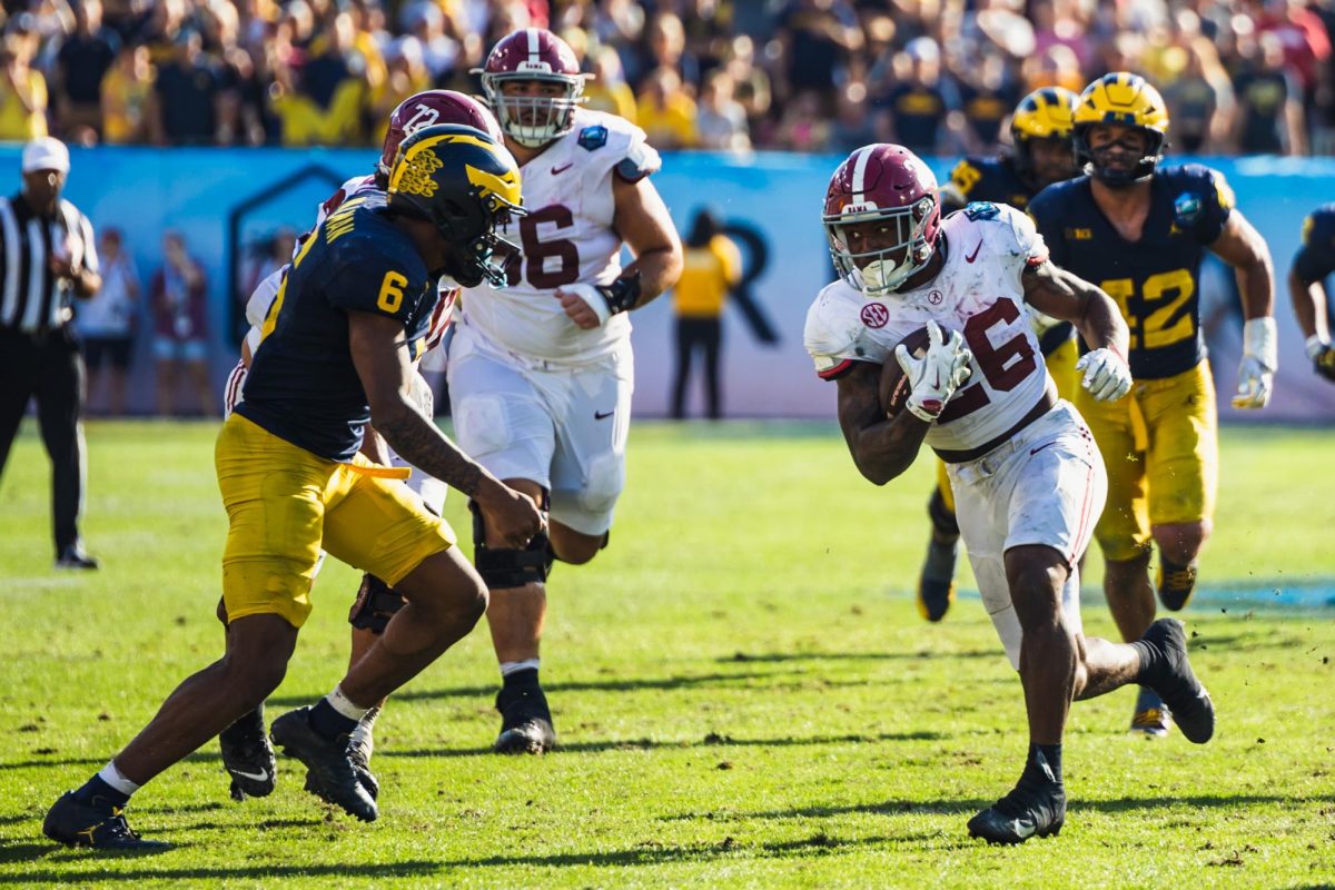 Alabama running back Jam Miller (#26) breaks through the Michigan defense during the ReliaQuest Bowl.