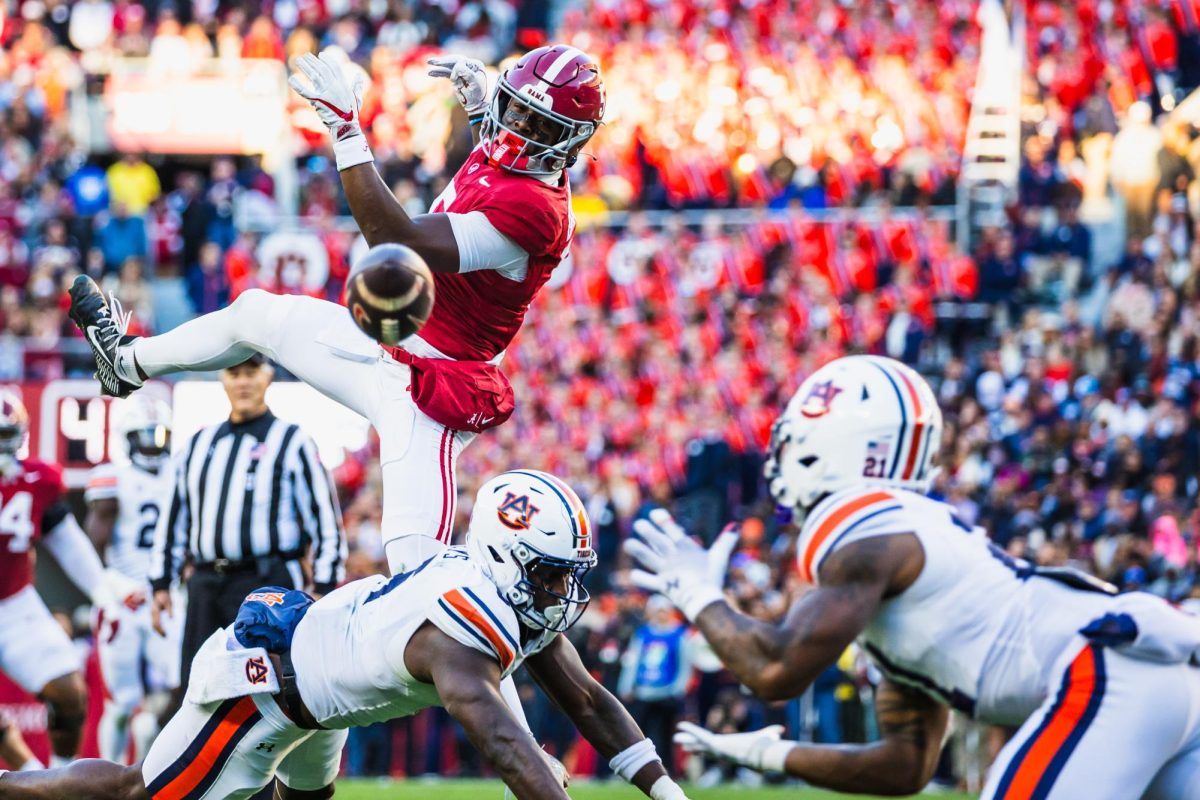 Auburn safety Caleb Wooden intercepts a pass from Alabama quarterback Jalen Milroe.  