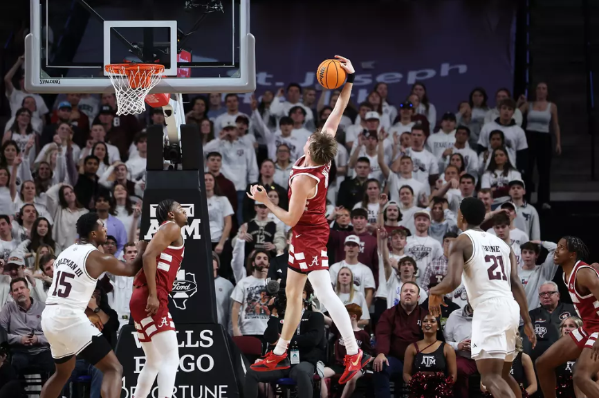 Alabama forward Grant Nelson (#4) dunks against Texas A&M.