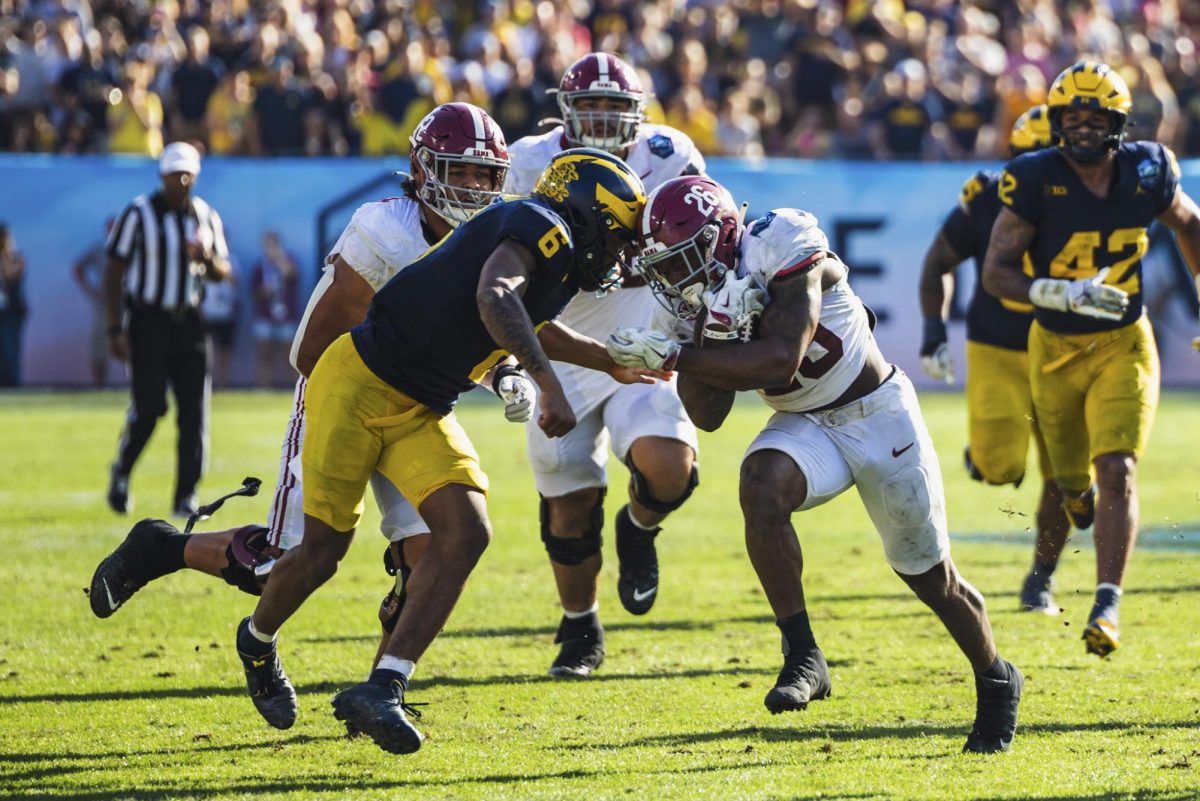 CW// Riley Thompson, Running back Jam Miller runs the ball in the 2025 ReliaQuest Bowl versus Michigan.