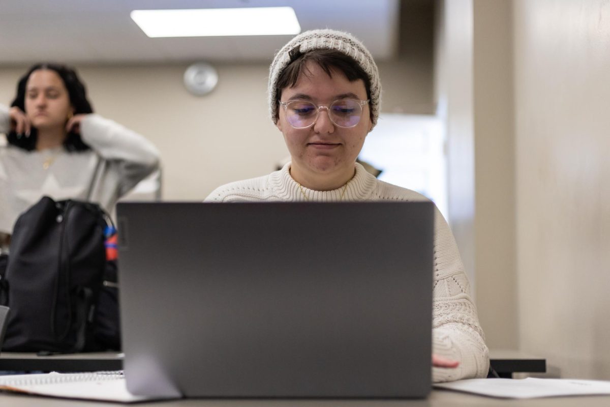 A student works on their laptop.