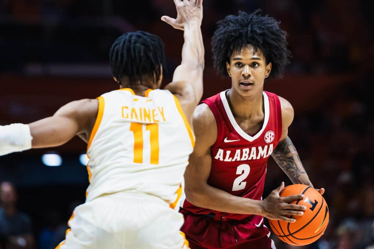 Alabama guard Aden Holloway (#2) looks down the court.