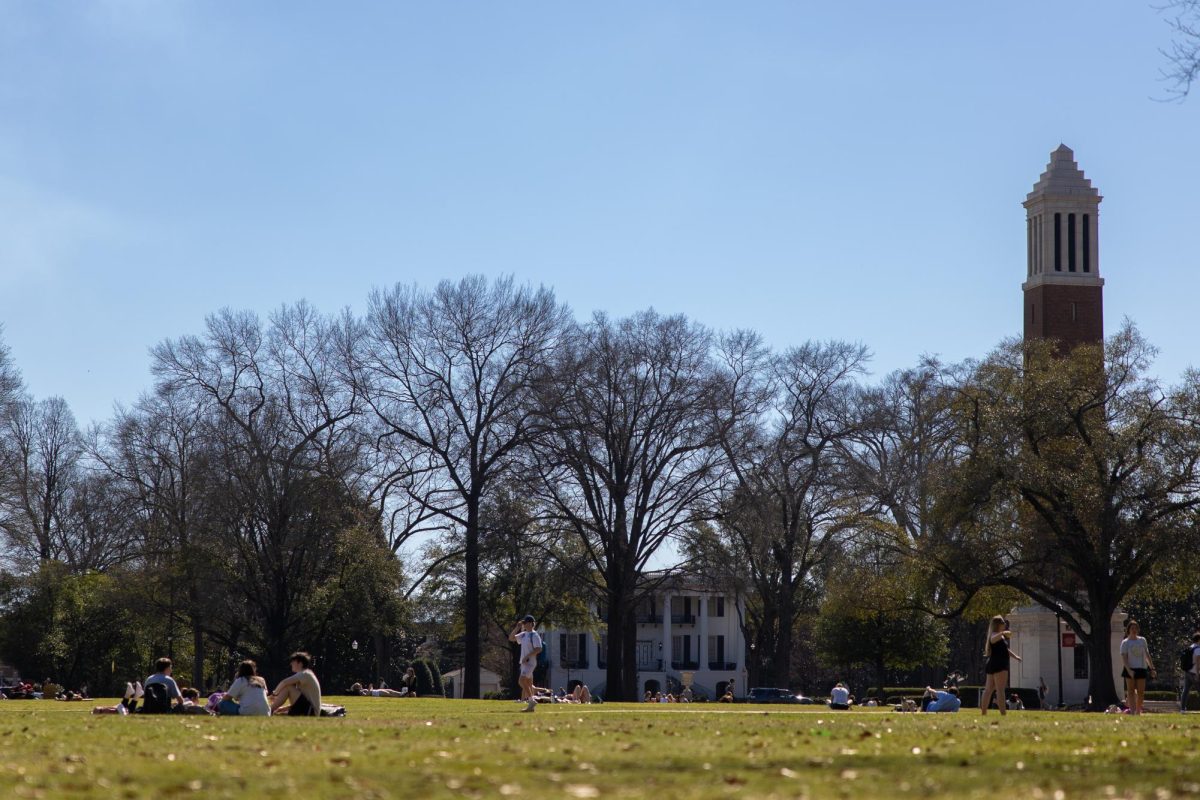 Students sit on the Quad during a sunny day.