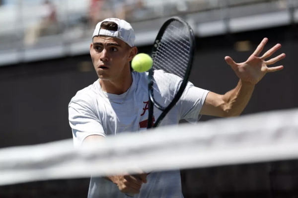 Alabama tennis player Zach Foster hits a backhand at the net against Mississippi State at The University of Alabama Tennis Stadium in Tuscaloosa, AL on April 13, 2025.

