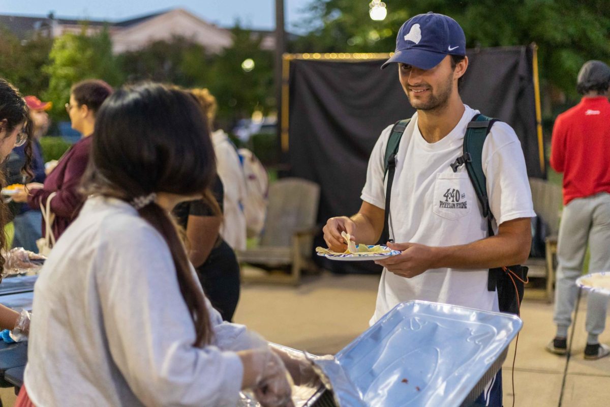 A student grabs food at the Hispanic Heritage Month event on October 10, 2024.