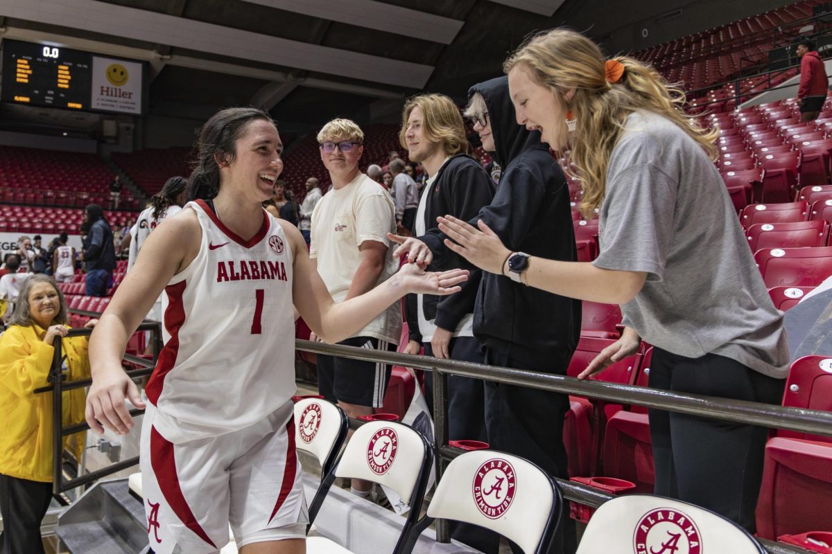 Alabama women's basketball guard Ace Austin celebrates with fans after a win versus Samford on Nov. 19, 2025, inside Coleman Coliseum in Tuscaloosa, Alabama.