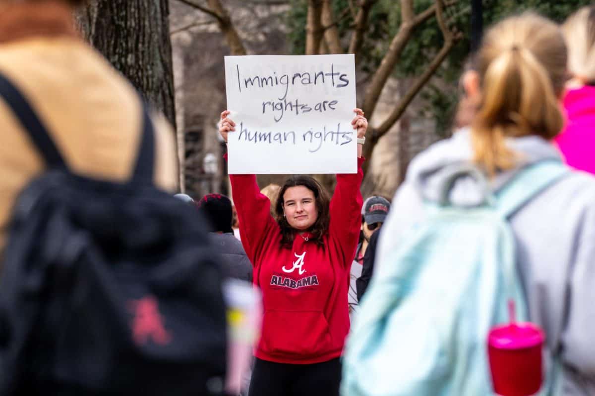A student holds up sign to show counter protesters. 