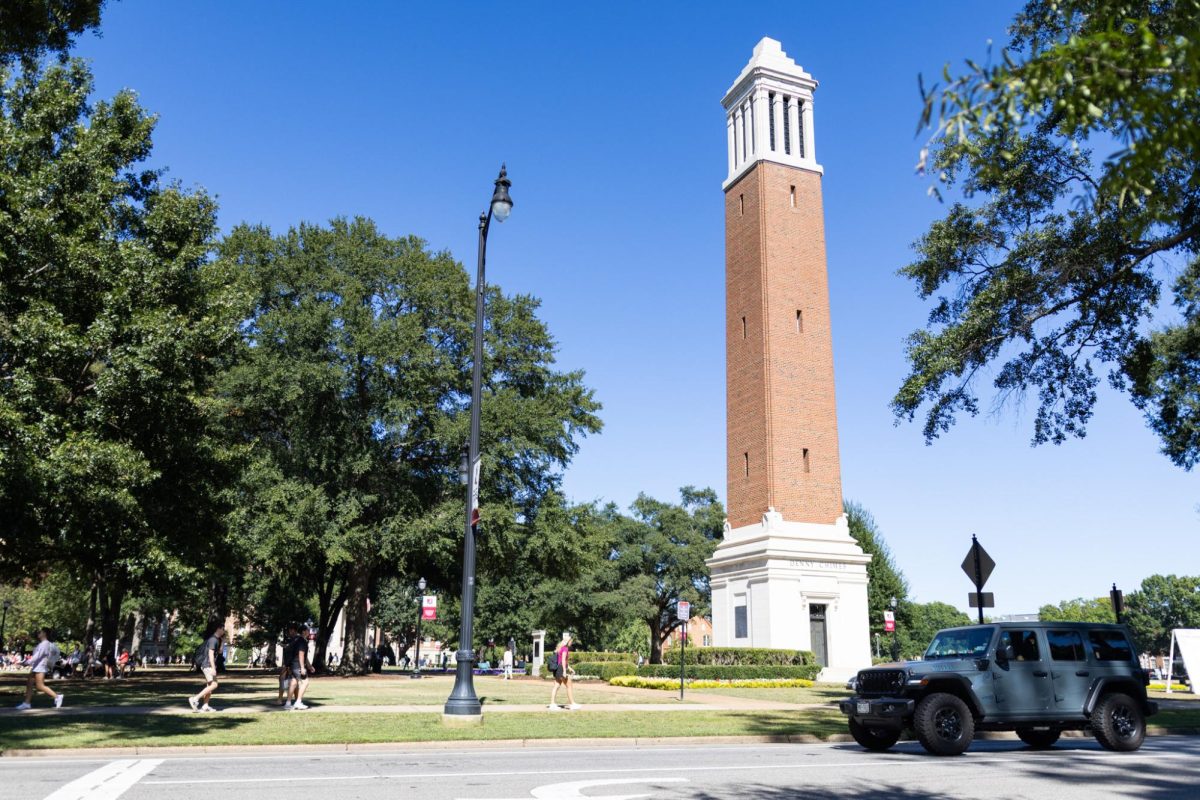 Students walk under Denny Chimes. 